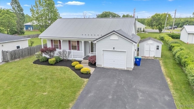 836 Upper Mountain Rd, Lewiston, NY 14092 - view of front of property with covered porch, a garage, asphalt driveway, and metal roof