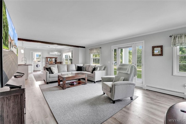 2194 Rte 39, Sheridan, NY 14062 - living area with baseboard heating, light wood-type flooring, crown molding, and washer / clothes dryer