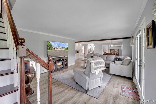 2194 Rte 39, Sheridan, NY 14062 - living room featuring crown molding, light wood-type flooring, stairway, a lit fireplace, and baseboards