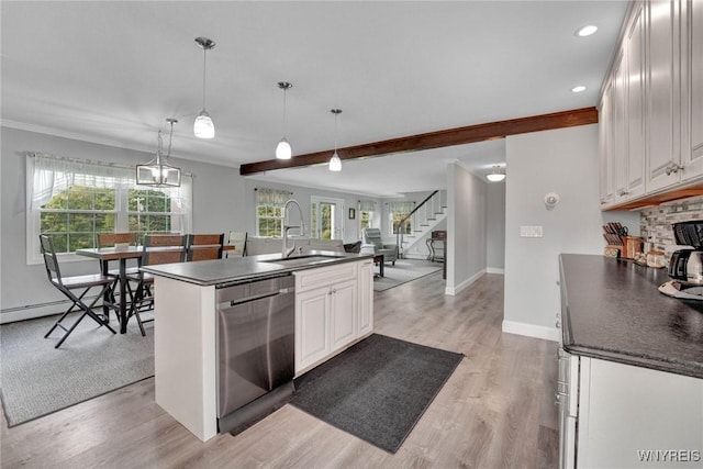 2194 Rte 39, Sheridan, NY 14062 - kitchen featuring stainless steel dishwasher, a sink, dark countertops, white cabinetry, and crown molding