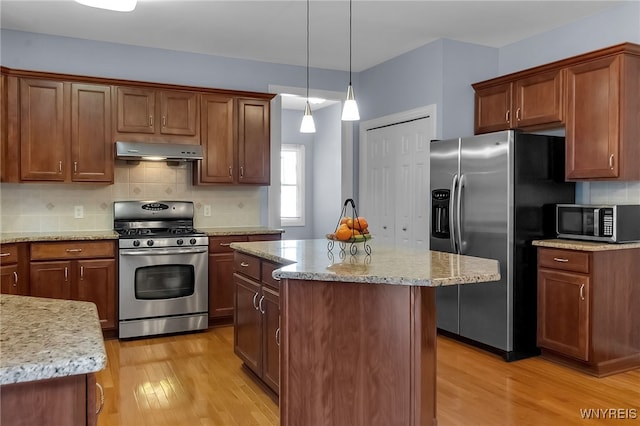 6017 Corinne Ln, Clarence, NY 14032 - kitchen featuring appliances with stainless steel finishes, extractor fan, light wood finished floors, light stone countertops, and backsplash