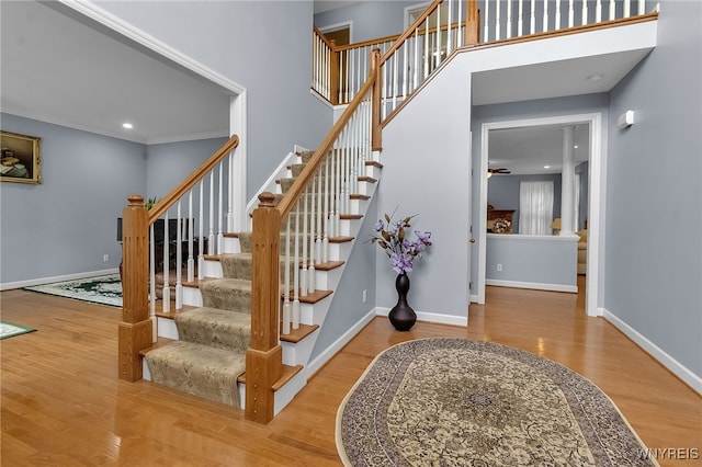 6017 Corinne Ln, Clarence, NY 14032 - staircase with wood finished floors, baseboards, a ceiling fan, and recessed lighting