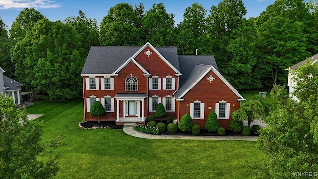 6017 Corinne Ln, Clarence, NY 14032 - view of front facade with brick siding and a front lawn