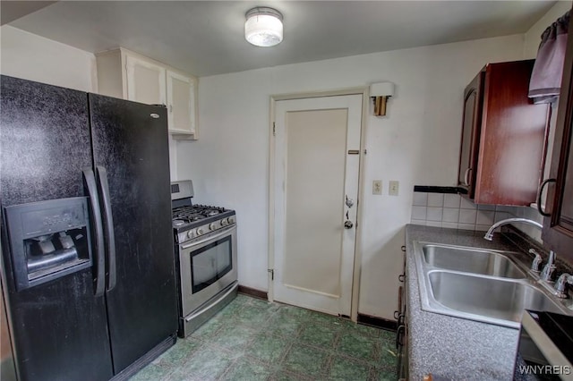 15 Arbour Ln, Buffalo, NY 14220 - kitchen with black fridge, gas stove, a sink, tile patterned floors, and decorative backsplash