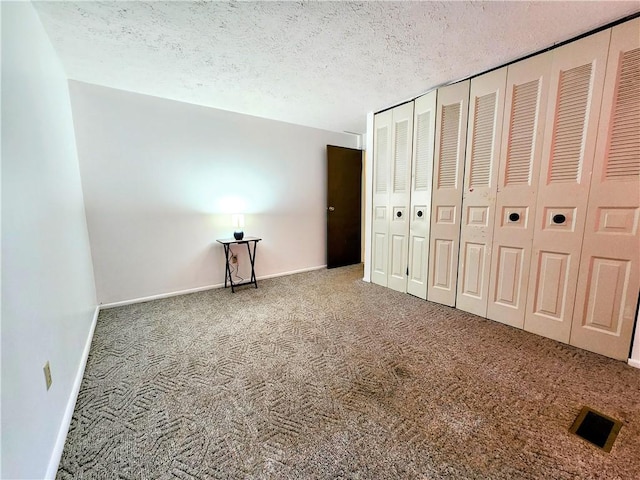 508 Countess Dr, Henrietta, NY 14586 - unfurnished bedroom with carpet, baseboards, and a textured ceiling