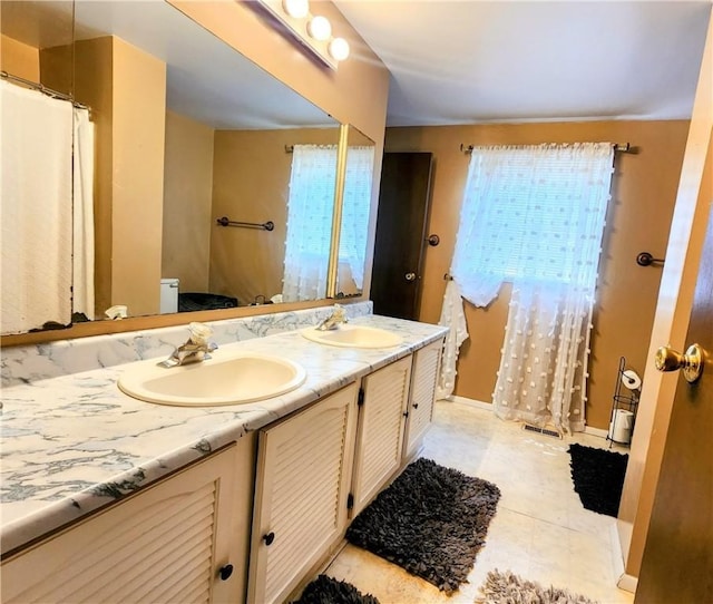 508 Countess Dr, Henrietta, NY 14586 - bathroom featuring toilet, double vanity, and baseboards
