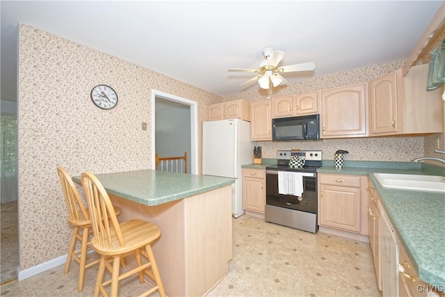 12 Sparrowbush Rd S, S, NY 12110 - kitchen featuring stainless steel electric stove, black microwave, freestanding refrigerator, light brown cabinets, and wallpapered walls