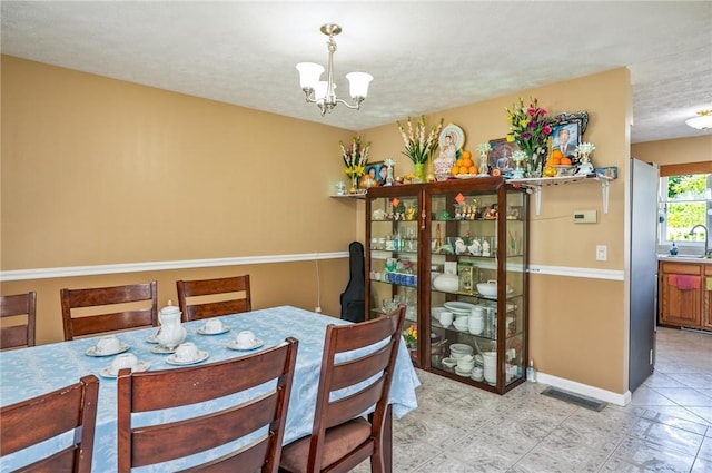 53 Toni Ter, Chili, NY 14624 - dining area featuring a chandelier and baseboards