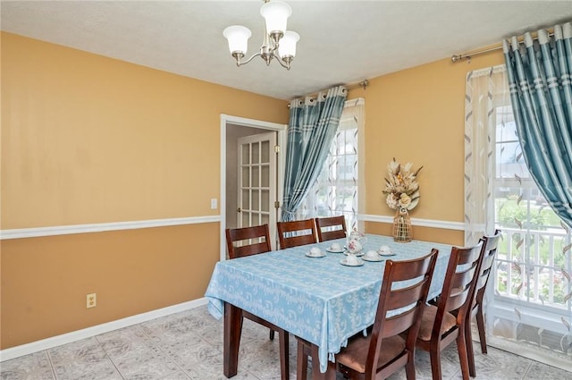 53 Toni Ter, Chili, NY 14624 - dining area with a chandelier and plenty of natural light