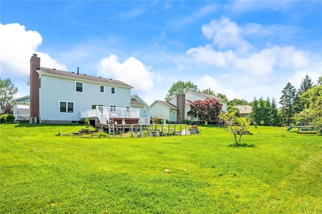 53 Toni Ter, Chili, NY 14624 - rear view of house featuring a chimney, a lawn, and a deck