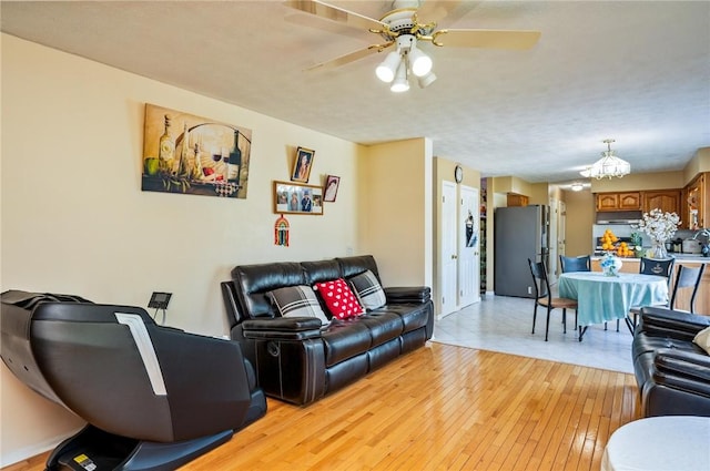 53 Toni Ter, Chili, NY 14624 - living room with light wood-style floors, a ceiling fan, and a chandelier