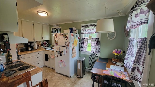 11 Parkview Ct, Arcade, NY 14009 - kitchen with freestanding refrigerator, plenty of natural light, white cabinetry, and crown molding