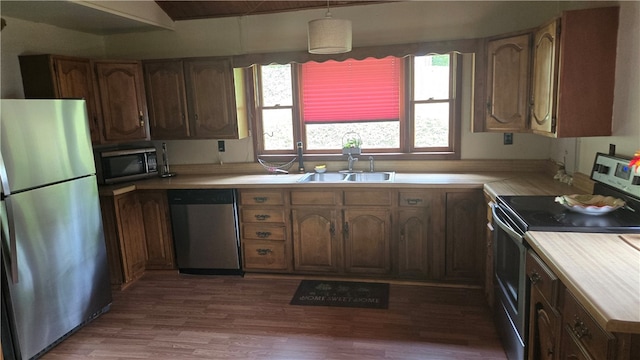 3976 Eddy Rd, Thurston, NY 14801 - kitchen featuring appliances with stainless steel finishes, a sink, light countertops, wood finished floors, and pendant lighting