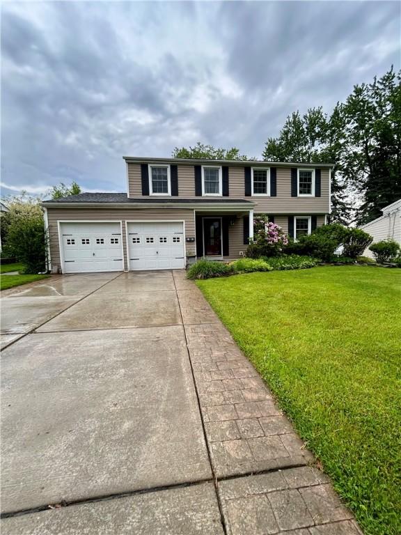 30 Sibley Dr, West Seneca, NY 14224 - view of front of home with driveway, an attached garage, and a front yard