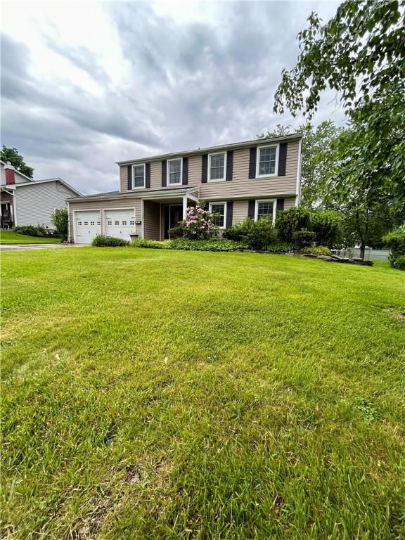 30 Sibley Dr, West Seneca, NY 14224 - view of front of house with a front yard, an attached garage, and driveway