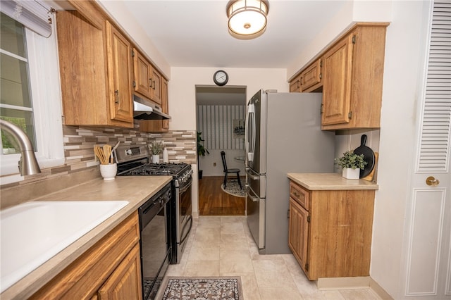 30 Sibley Dr, West Seneca, NY 14224 - kitchen featuring a sink, black dishwasher, under cabinet range hood, freestanding refrigerator, and stainless steel gas range