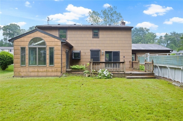69 Tree Brook Dr, Penfield, NY 14625 - rear view of house with a deck, a chimney, and a lawn