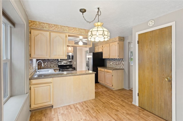 69 Tree Brook Dr, Penfield, NY 14625 - kitchen featuring stainless steel appliances, light brown cabinets, a sink, backsplash, and a peninsula