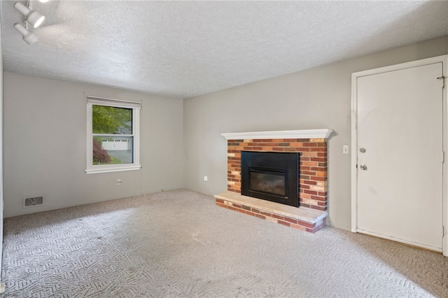 69 Tree Brook Dr, Penfield, NY 14625 - unfurnished living room featuring carpet, a textured ceiling, and a fireplace