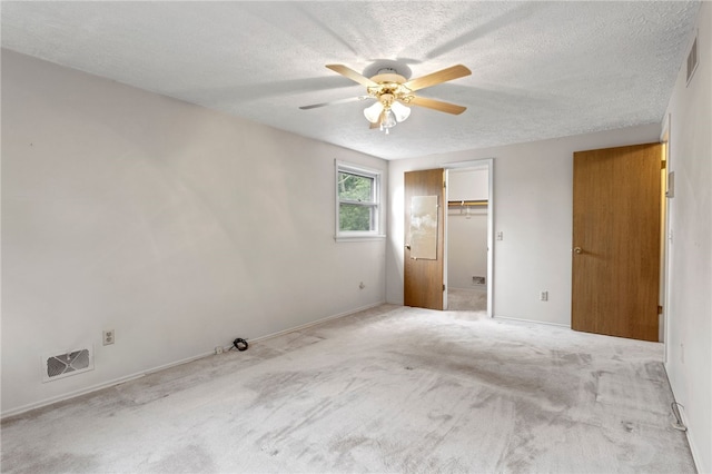 69 Tree Brook Dr, Penfield, NY 14625 - unfurnished bedroom featuring a textured ceiling, a ceiling fan, light carpet, a closet, and baseboards