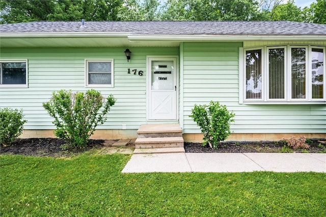 176 Wildbriar Rd, Henrietta, NY 14623 - view of exterior entry featuring a lawn and roof with shingles