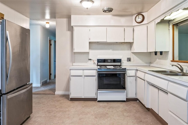 176 Wildbriar Rd, Henrietta, NY 14623 - kitchen with freestanding refrigerator, white range with gas cooktop, a sink, light countertops, and white cabinetry