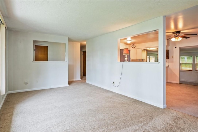176 Wildbriar Rd, Henrietta, NY 14623 - spare room with carpet flooring, a ceiling fan, a textured ceiling, and baseboards