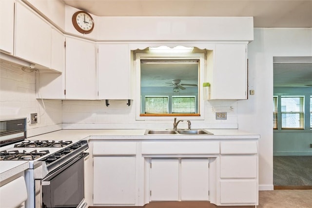 176 Wildbriar Rd, Henrietta, NY 14623 - kitchen featuring white gas range, a sink, light countertops, white cabinets, and backsplash