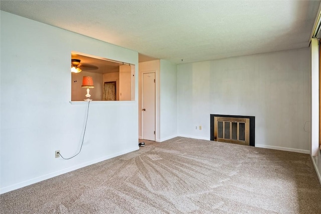 176 Wildbriar Rd, Henrietta, NY 14623 - unfurnished living room featuring a glass covered fireplace, carpet, baseboards, and a textured ceiling