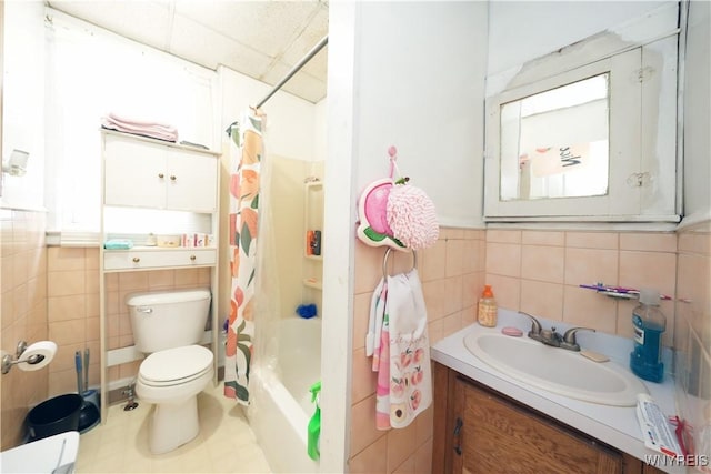 132 Weiss St, Buffalo, NY 14206 - bathroom with tile walls, vanity, toilet, shower / bath combo, and wainscoting