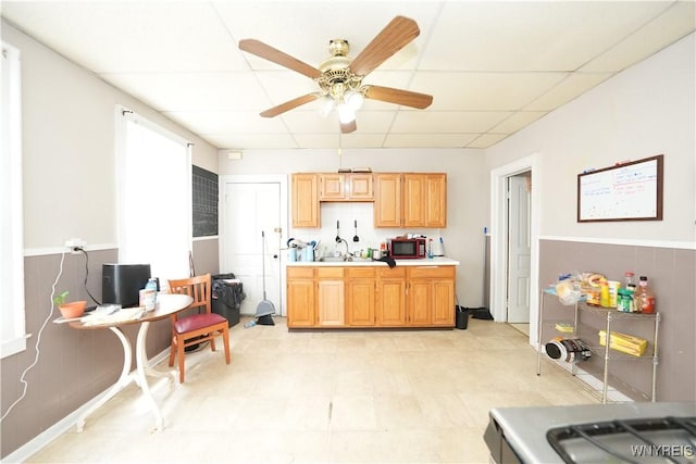 132 Weiss St, Buffalo, NY 14206 - kitchen featuring stainless steel microwave, a ceiling fan, light countertops, a drop ceiling, and a sink