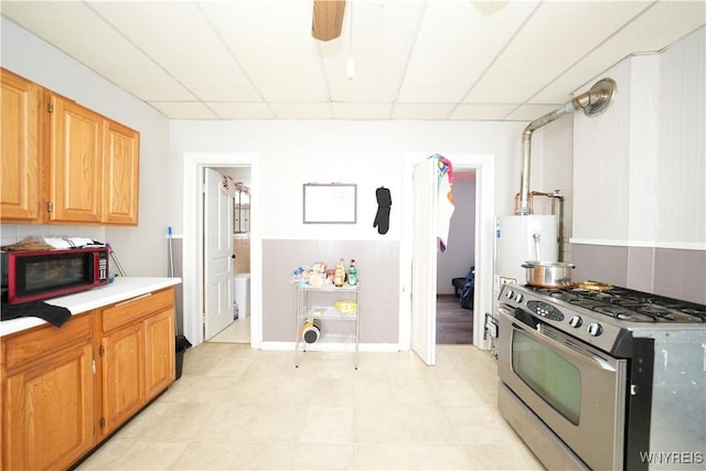 132 Weiss St, Buffalo, NY 14206 - kitchen featuring gas stove, a paneled ceiling, light countertops, a ceiling fan, and gas water heater