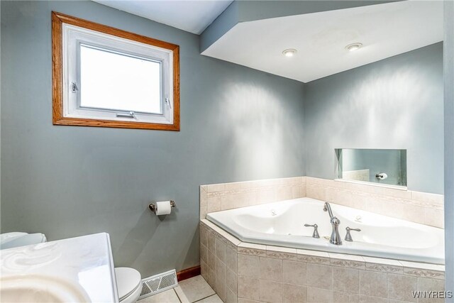 201 Bernadette, West Seneca, NY 14224 - bathroom featuring a garden tub, toilet, tile patterned flooring, and baseboards