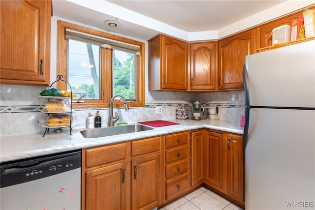 201 Bernadette, West Seneca, NY 14224 - kitchen featuring stainless steel appliances, a sink, brown cabinets, decorative backsplash, and light tile patterned flooring