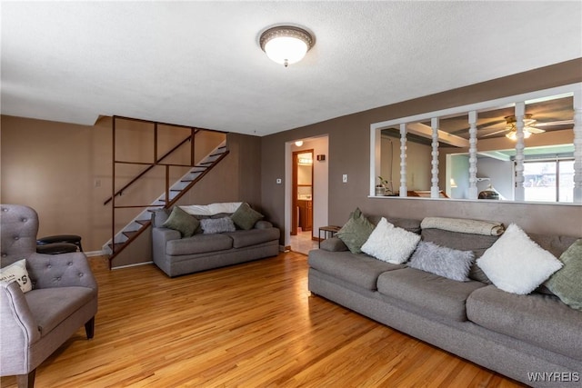 201 Bernadette, West Seneca, NY 14224 - living area featuring wood finished floors, stairs, a ceiling fan, and baseboards