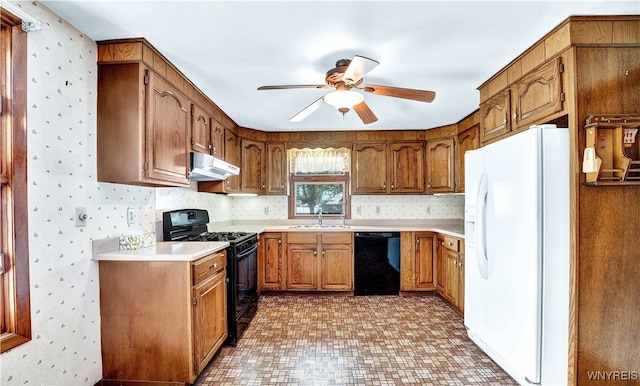 63 Princeton Ct, Cheektowaga, NY 14225 - kitchen featuring black appliances, under cabinet range hood, ceiling fan, brown cabinets, and wallpapered walls