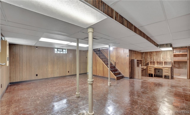 63 Princeton Ct, Cheektowaga, NY 14225 - below grade area with wooden walls, a drop ceiling, stairway, and baseboards