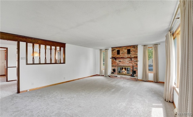 63 Princeton Ct, Cheektowaga, NY 14225 - unfurnished living room with carpet floors, a fireplace, baseboards, and a textured ceiling