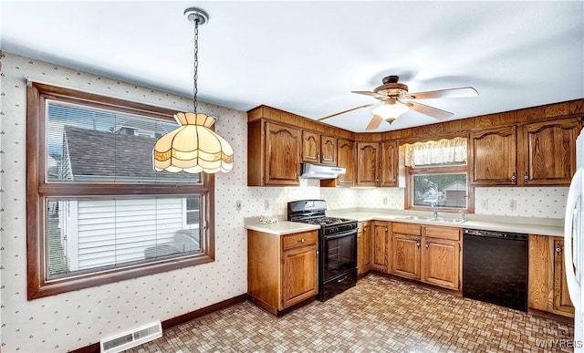 63 Princeton Ct, Cheektowaga, NY 14225 - kitchen featuring black appliances, wallpapered walls, under cabinet range hood, a sink, and brown cabinets