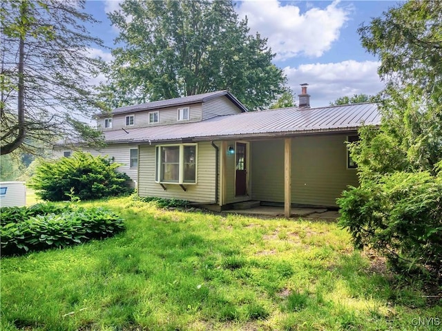 1010 Simmons Rd, Sterling, NY 13156 - rear view of house featuring metal roof and a chimney