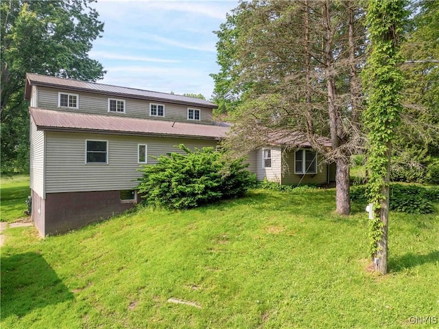 1010 Simmons Rd, Sterling, NY 13156 - rear view of house with a lawn and metal roof