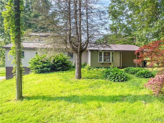 1010 Simmons Rd, Sterling, NY 13156 - view of front of home featuring metal roof and a front lawn