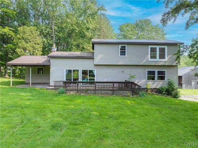 1010 Simmons Rd, Sterling, NY 13156 - rear view of house featuring a lawn, metal roof, and a wooden deck