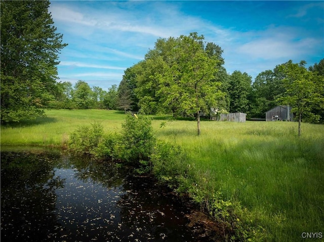 1010 Simmons Rd, Sterling, NY 13156 - view of yard featuring an outbuilding and a water view