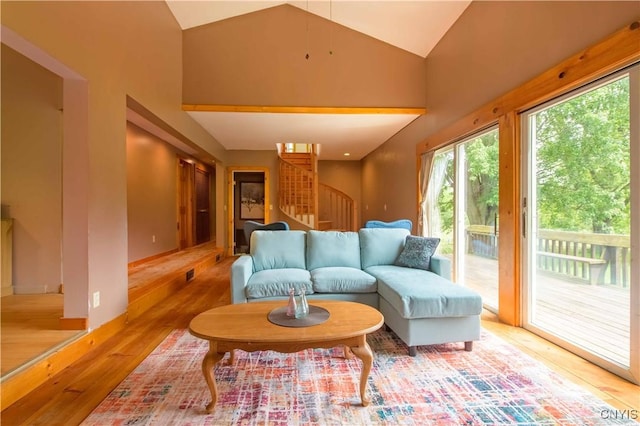 1010 Simmons Rd, Sterling, NY 13156 - living room with stairway, wood finished floors, and high vaulted ceiling