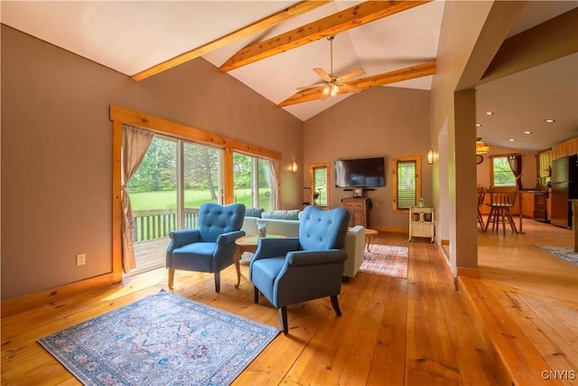 1010 Simmons Rd, Sterling, NY 13156 - living room featuring light wood-type flooring, beam ceiling, high vaulted ceiling, ceiling fan, and baseboards
