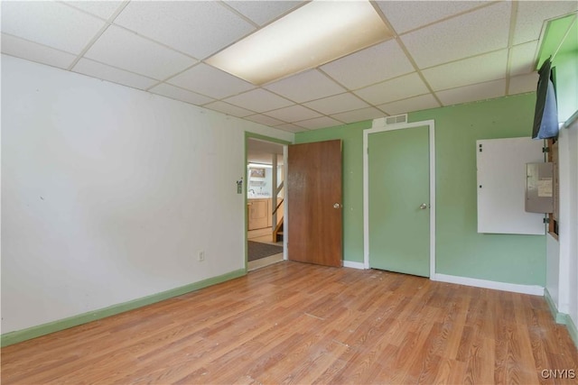 1010 Simmons Rd, Sterling, NY 13156 - spare room featuring a drop ceiling, wood finished floors, and baseboards