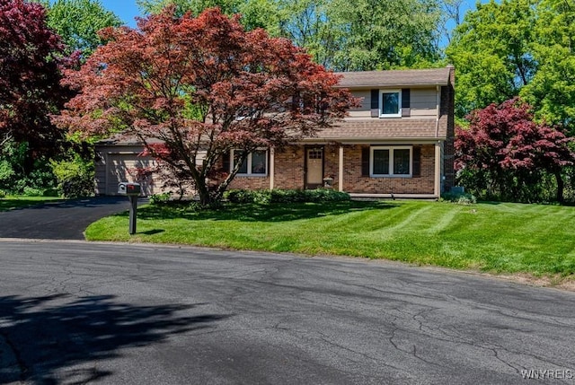 18 Tree Top Dr, Penfield, NY 14625 - view of front of home with driveway, a front yard, brick siding, and a garage