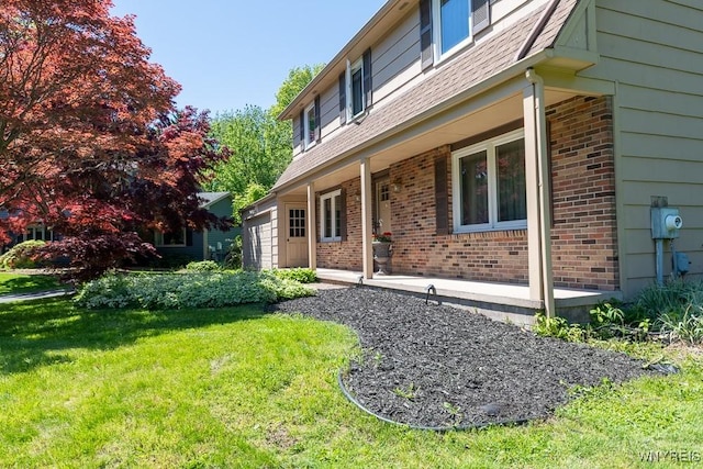 18 Tree Top Dr, Penfield, NY 14625 - view of side of home with brick siding, a yard, and a porch