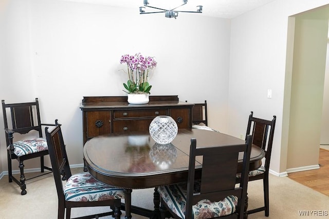 18 Tree Top Dr, Penfield, NY 14625 - dining space featuring light colored carpet, baseboards, and a chandelier